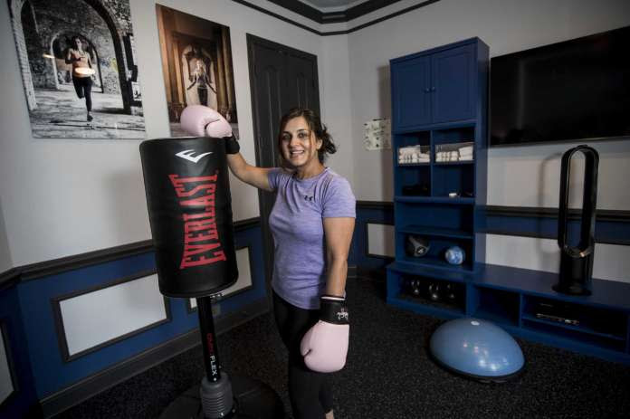 woman with boxing gloves in an excercise room